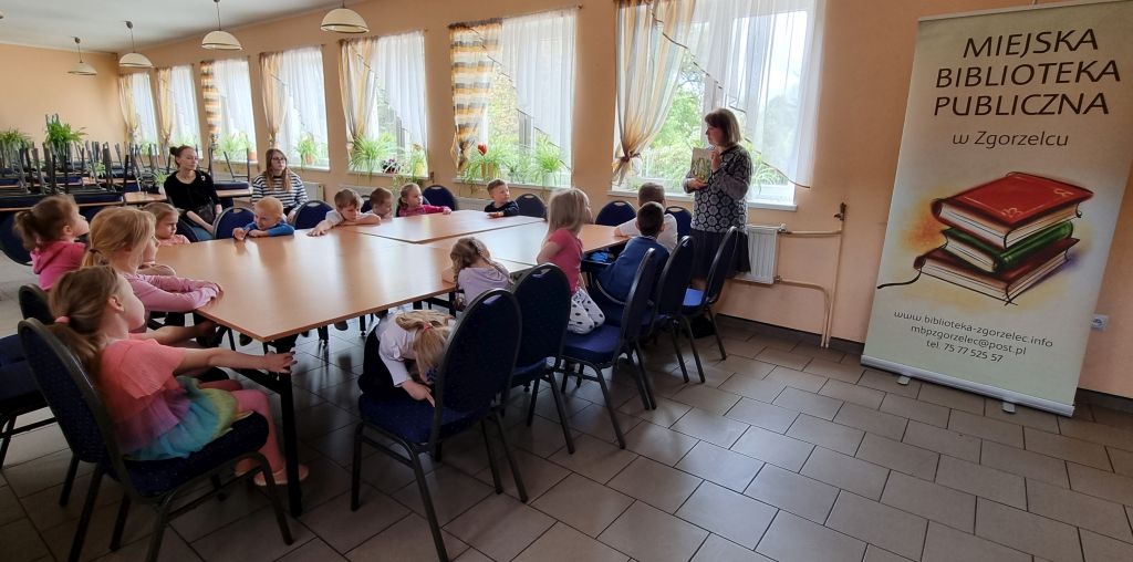 Bibliotekarka prezentuje przedszkolakom książkę z wierszem Jana Brzechwy pt. "Żuraw i czapla".