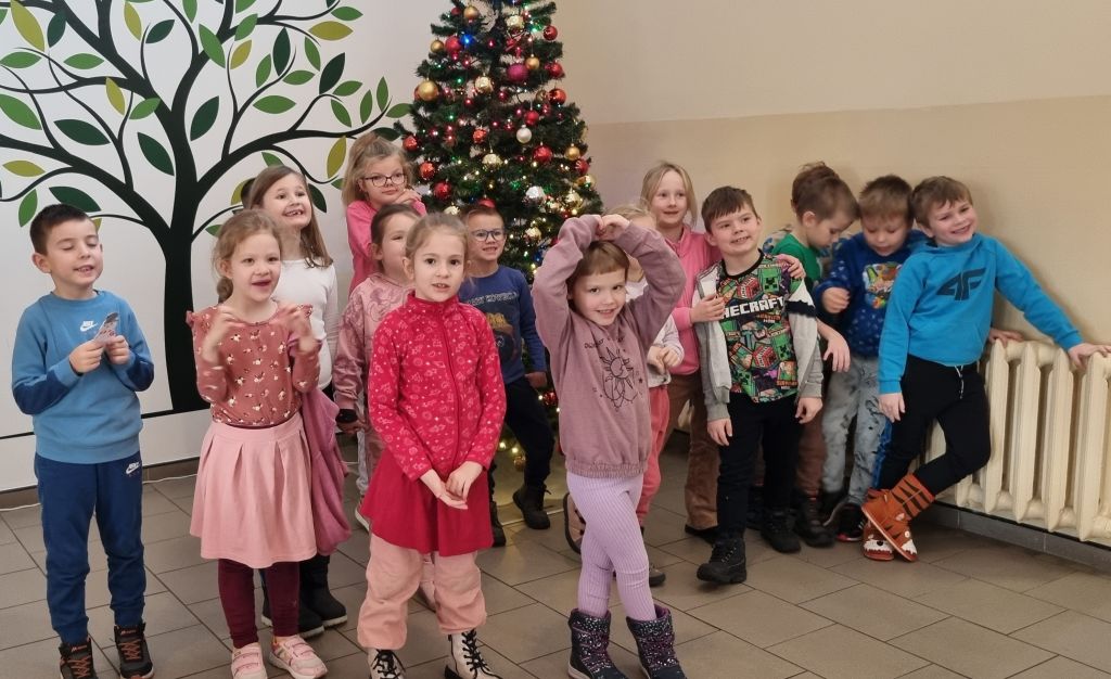 Wspólne zdjęcie przedszkolaków przy choince. Zdjęcie jest odnośnikiem do wpisu: "Świąteczne niespodzianki".